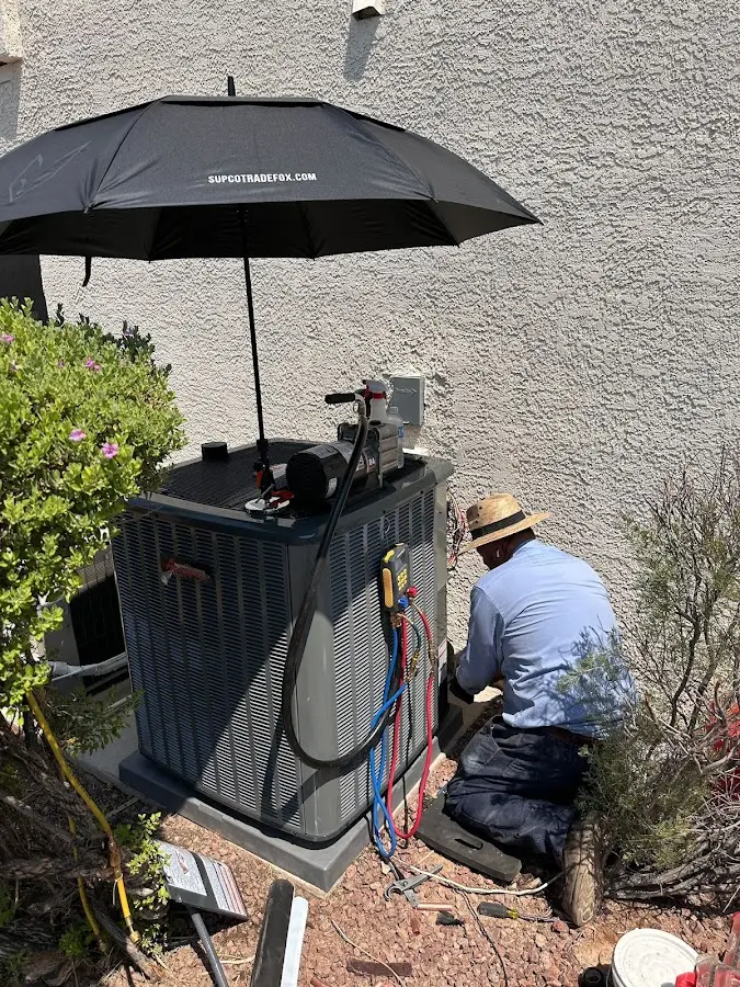 HVAC technician performing outdoor AC maintenance in Gas City